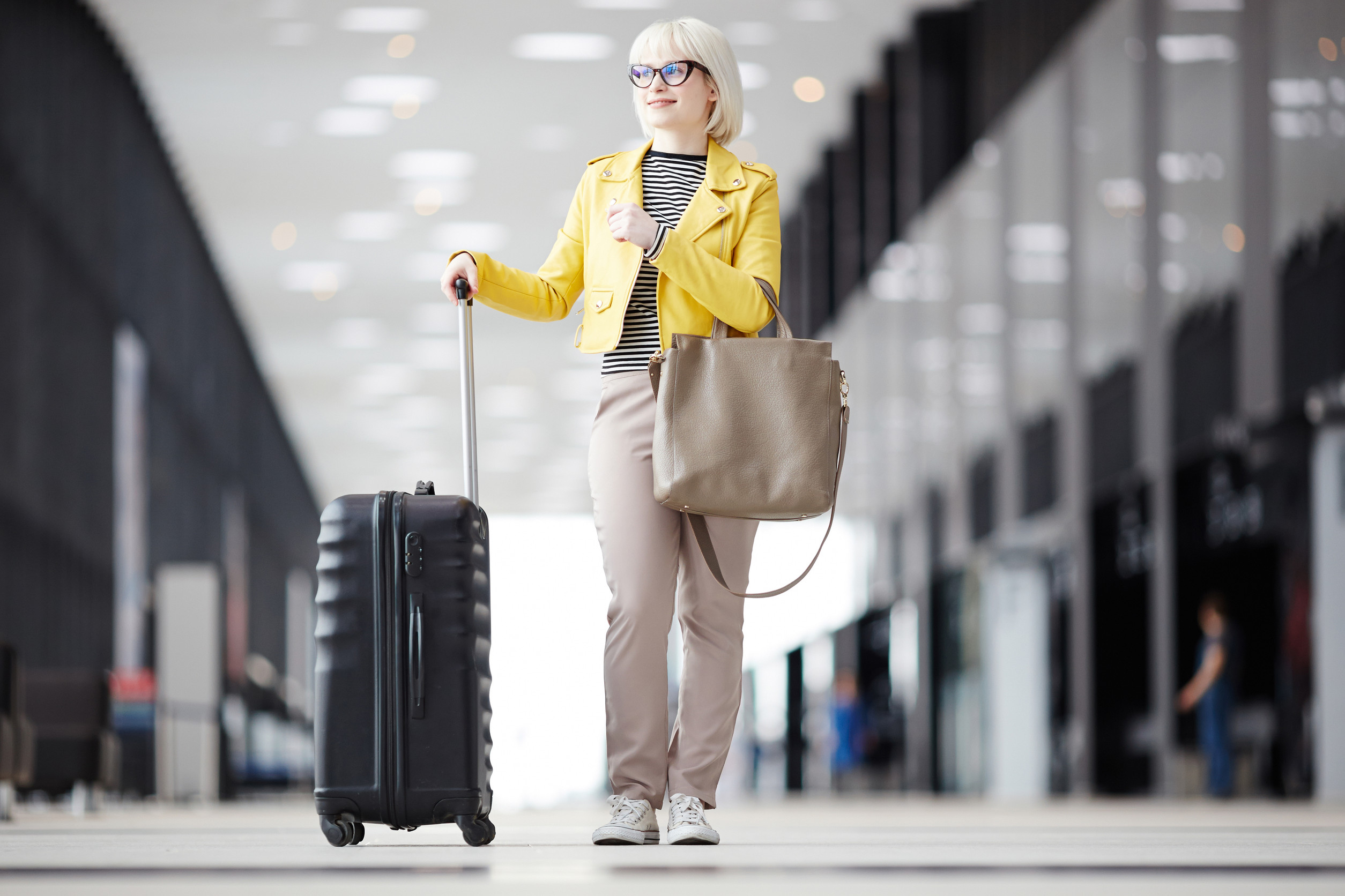 Woman standing with suitcase
